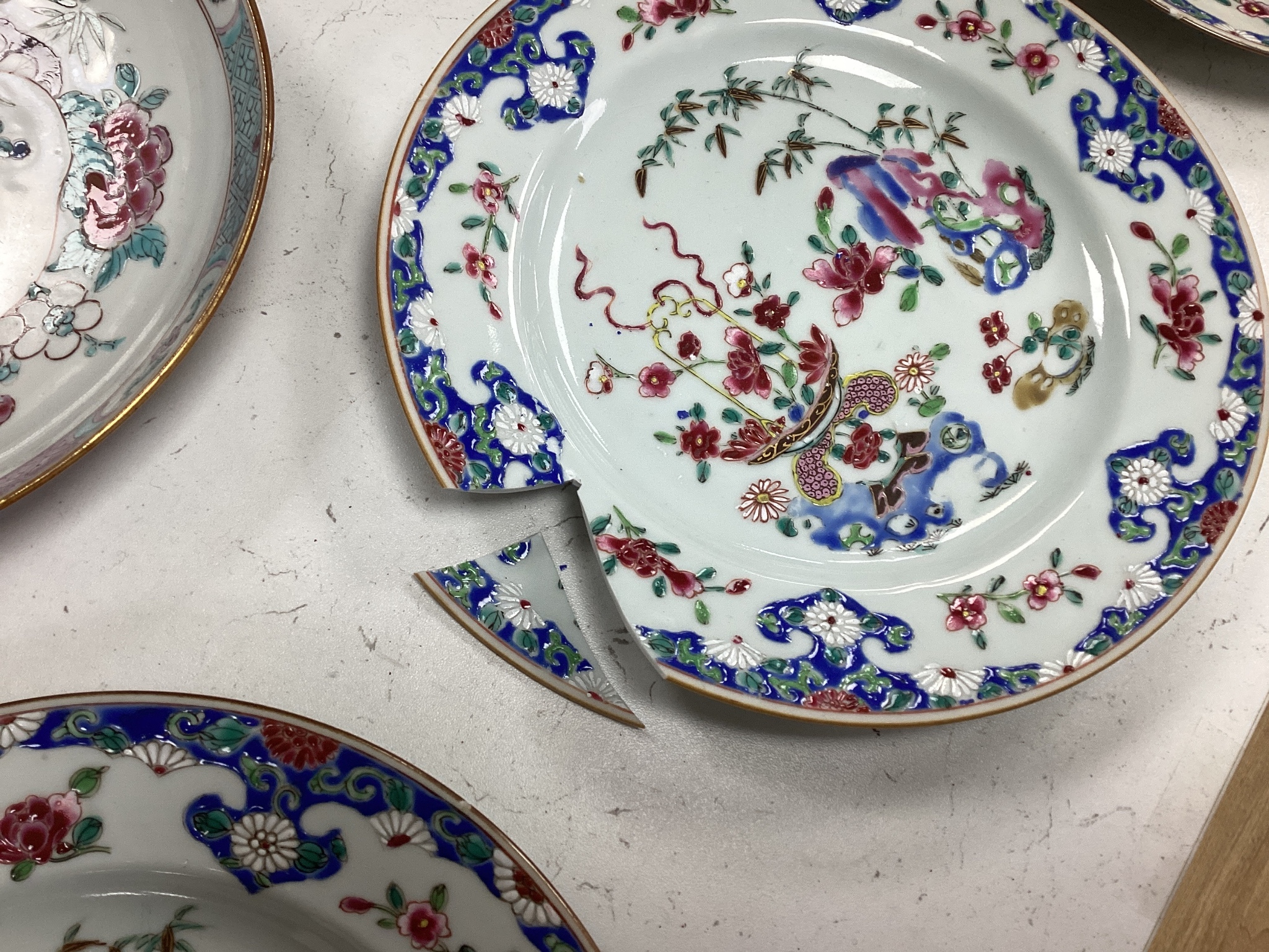 A Set of three 18th century Chinese export famille rose plates and a similar dish, largest 22.5cm diameter